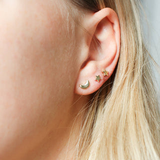 Moon Stud Earring paired with star stud earrings being worn