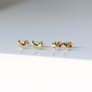 Star stud earrings alongside Moon stud earrings in sunlight front view