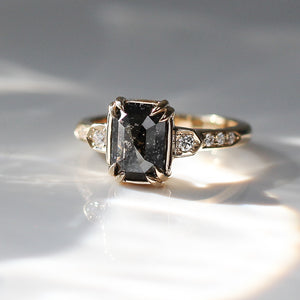 Rectangular cut black diamond ring in sunlight quarter view