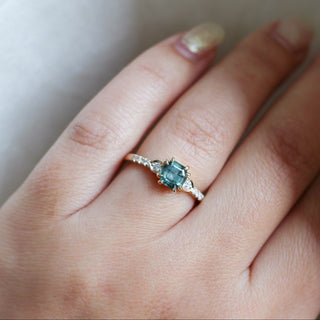 Cut Corner Rectangle Step Cut Greeen Sapphire Ring on hand in sunlight