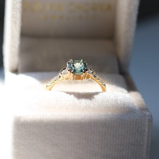 Cut Corner Rectangle Step Cut Green Sapphire Ring side view in jewellery box in sunlight