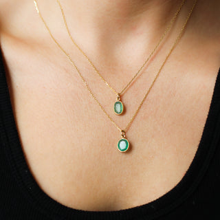 Large Emerald Bezel Charms being worn as necklaces on paperclip chains