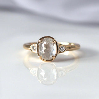 Custom oval engagement ring with ethically sourced diamond centre stone in a gold setting, handcrafted by Yuliya Chorna at her Toronto studio.