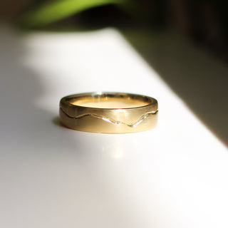 18k yellow gold wide wedding band with organic handcarved line, front view
