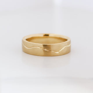 18k yellow gold wide wedding band with organic handcarved line, front view