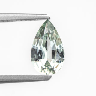 Pear brilliant cut mint green sapphire in tongs