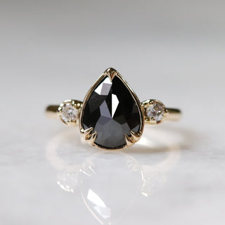 Custom engagement ring with ethically sourced black diamond centre stone in a gold setting, handcrafted by Yuliya Chorna at her Toronto studio.