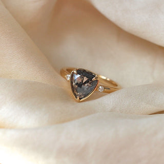 Black diamond centre stone with diamond accent stones in a gold signature ring setting.