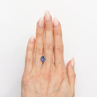 Pear cut blue sapphire on hand
