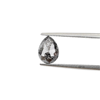 Pear shaped salt and pepper diamond in tongs