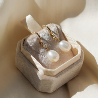 Pearl and diamond drop hoop earrings in jewellery box, quarter view