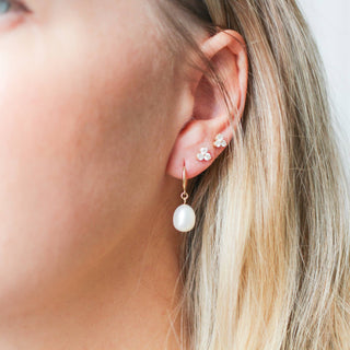 Pearl Drop Hoop Earrings paired with diamond gold earrings being worn