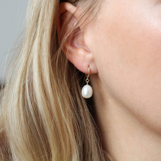 Pearl Drop Hoop Earrings being worn close up