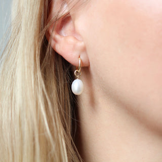 Pearl Drop Charm on a hoop earring being worn