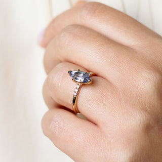 Marquise blue sapphire engagement ring quarter view on hand