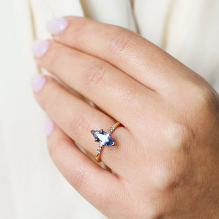 Marquise blue sapphire engagement ring close up on hand