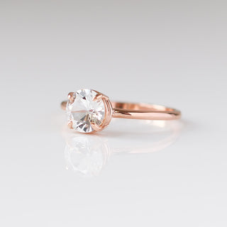 round white sapphire solitaire engagement ring three quarter view 