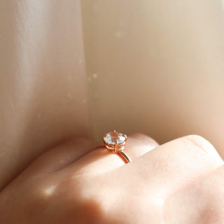 round white sapphire solitaire engagement ring worn in side view