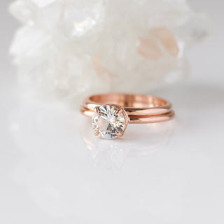 round white sapphire solitaire engagement ring paired with thin band