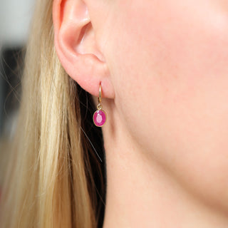 Red Ruby Bezel Drop Hoop Earrings being worn 