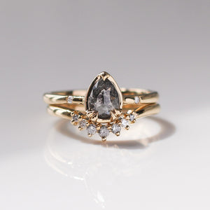 Grey Diamond band in yellow gold stacked with pear salt and pepper diamond gold ring front view