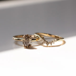 Sahara Champagne Diamond stacking ring beside oval champagne solitaire engagement ring, front view