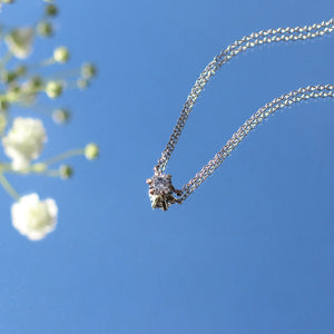 Salt & Pepper 6-prong Diamond Necklace with flowers and reflection