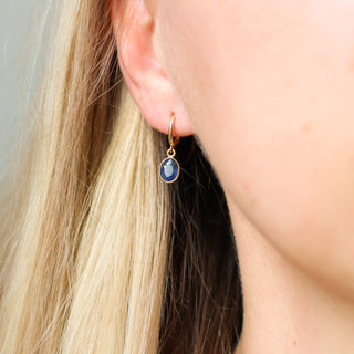 Blue Sapphire Bezel Drop Hoop Earrings being worn 