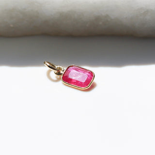 Small Ruby Bezel Charm in sunlight side view