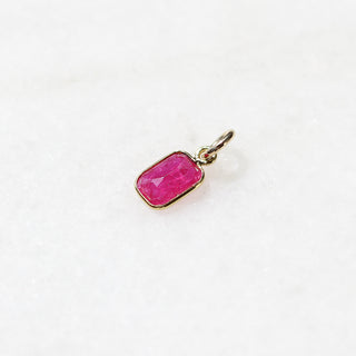 Small Ruby Bezel Charm quarter side view on marble