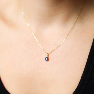 Blue Sapphire Bezel Charm being worn as a necklace