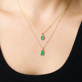 Green Charms being worn as necklaces on paperclip chains front view