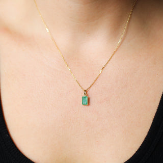 Small Emerald Bezel Charm being worn as a necklace front view