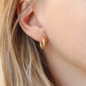 Diamond Cut Gold Hoop Earings on ear three quarter view