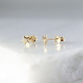 Star Stud Earrings side view on marble