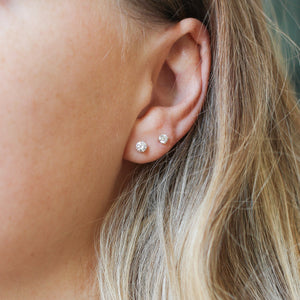 Round Diamond Stud Earrings on ear