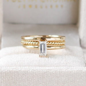 White sapphire ring with gold bands