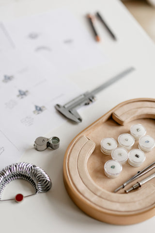 Assorted jewelry-making tools and materials for custom ring design at the Yuliya Chorna studio in Toronto.