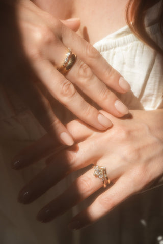 Bride wearing diamond stacking bands and custom diamond engagement ring with matching wedding band.