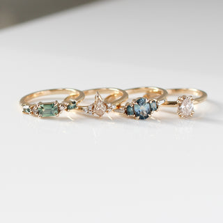 Set of gold rings with gemstones on a light background