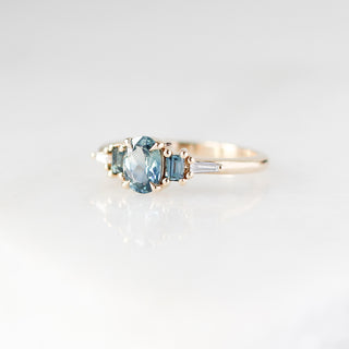 Yellow gold ring with blue sapphires, quarter view