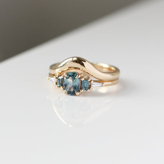 Yellow gold ring with blue sapphires and a yellow gold contour band, front view