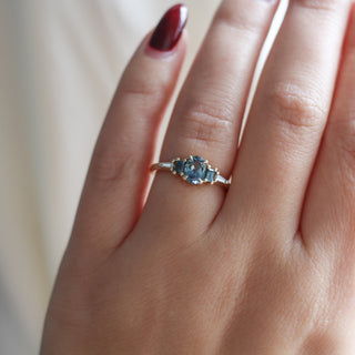 Yellow gold ring with blue sapphires, on hand