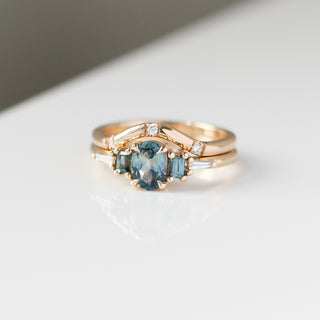 Yellow gold ring with blue sapphires and a three diamond contour band, front view