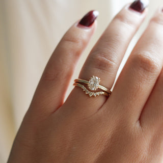 yellow gold diamond solitaire ring with diamond contour band on hand