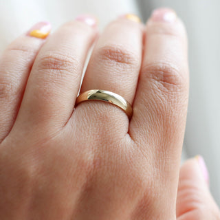 Classic light 4mm band in yellow gold on hand close up