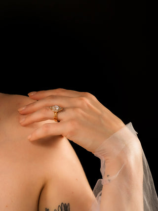 Cushion cut diamond halo ring on hand 