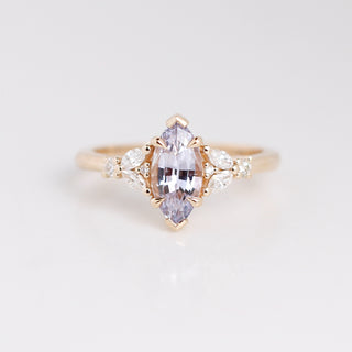 Yellow gold engagement ring with a lavender marquise sapphire and white diamond accents