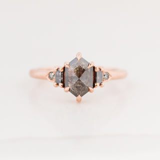 Rose gold engagement ring with a hexagon salt and pepper diamond, with an ombre effect of smaller salt and pepper diamonds framing it