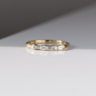 Yellow gold wedding band with baguette cut and round brilliant cut lab diamonds, quarter view